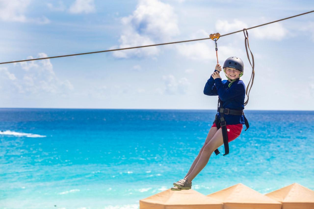 Crown Paradise Club Cancun Exterior photo A child on a zip line